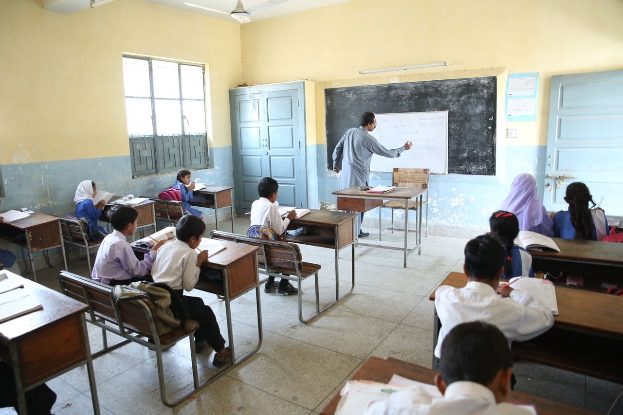 A classroom with the teacher at the board