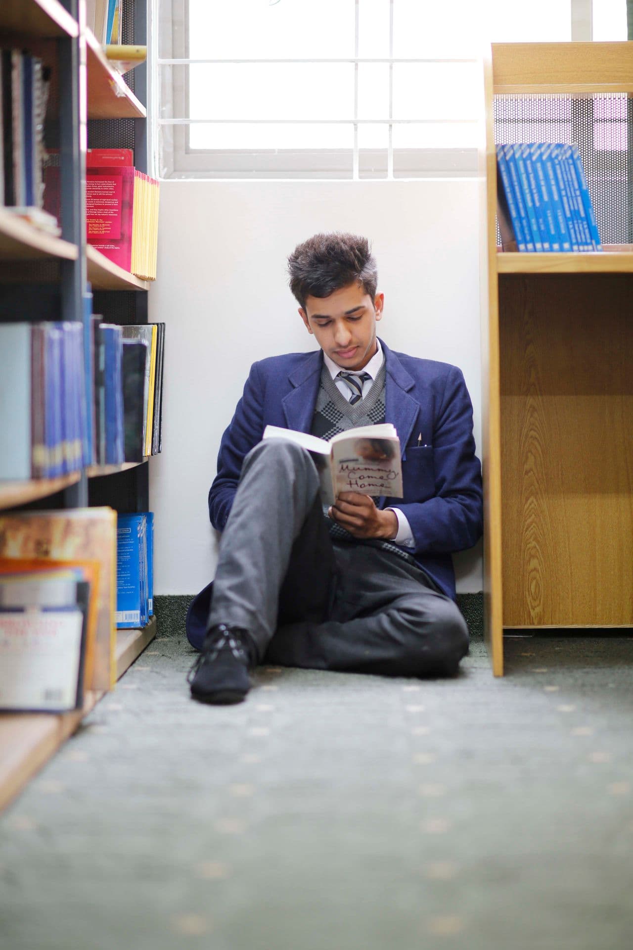 A student reading in a library corner