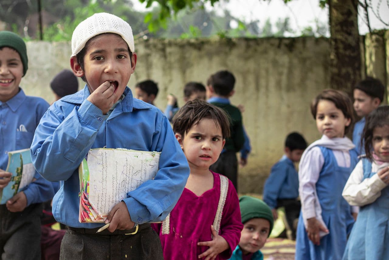 Students outdoors holding their notebooks
